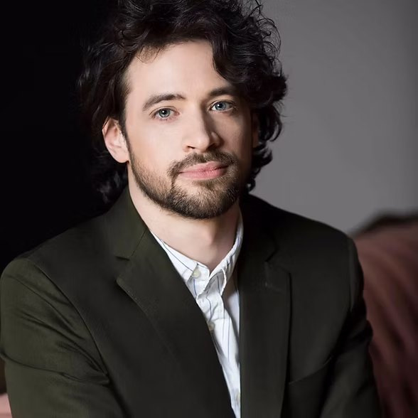 Portrait du pianiste Tristan Longval-Gagné, veston vert foncé